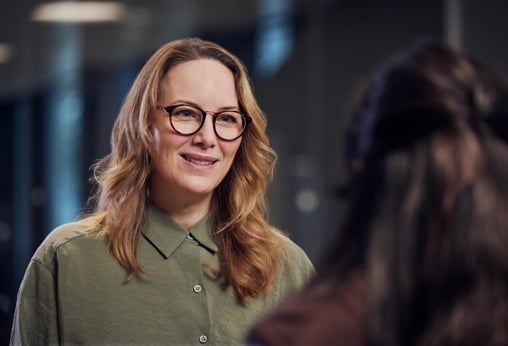 A woman talking to a colleague portrait